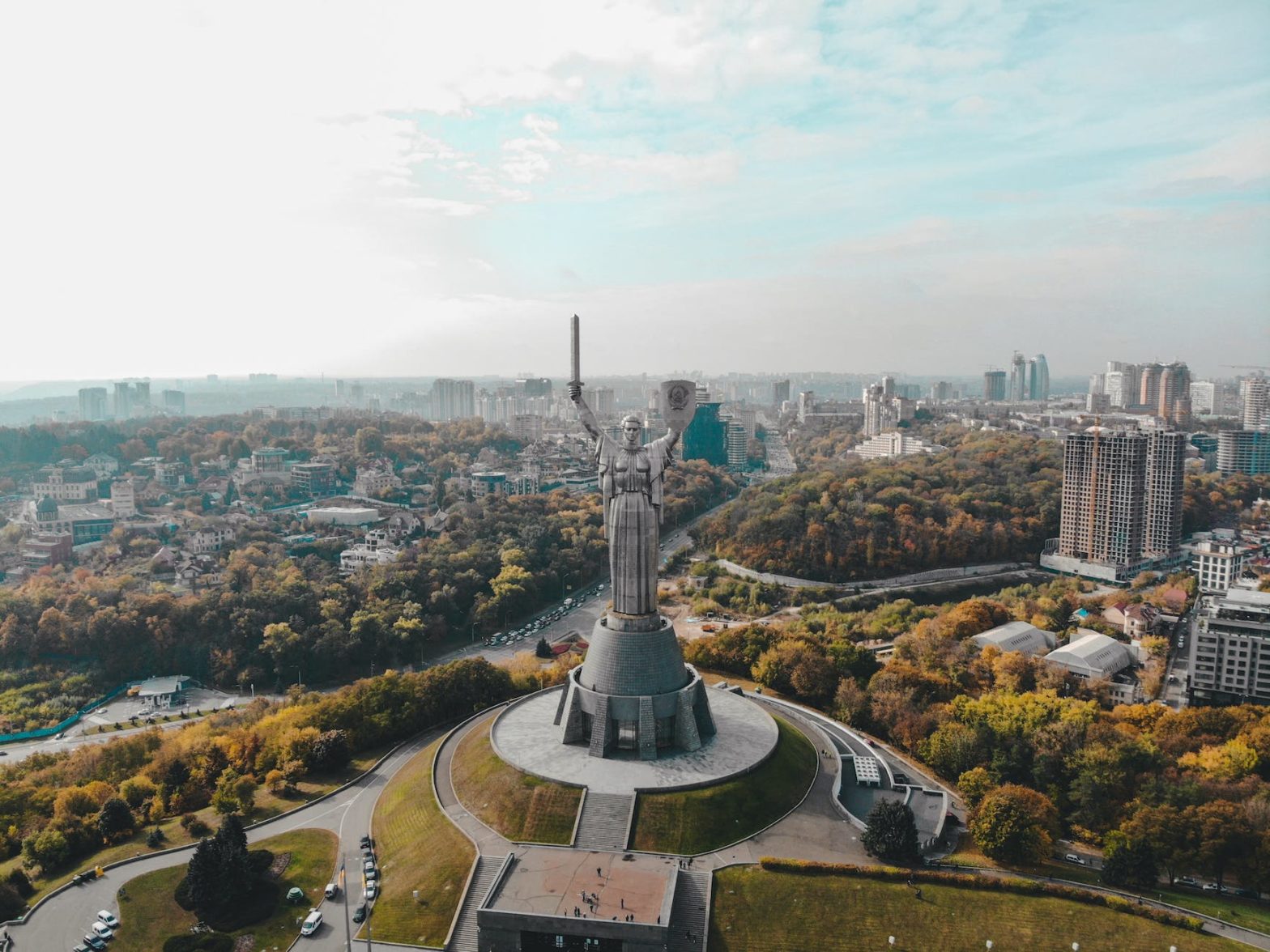 drone shot of motherland monument and the city of kyiv