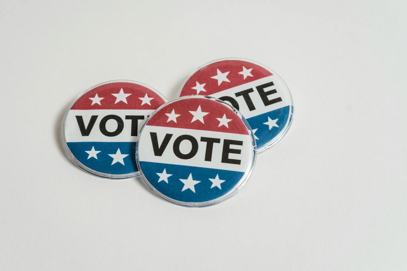 us voting badges on white surface